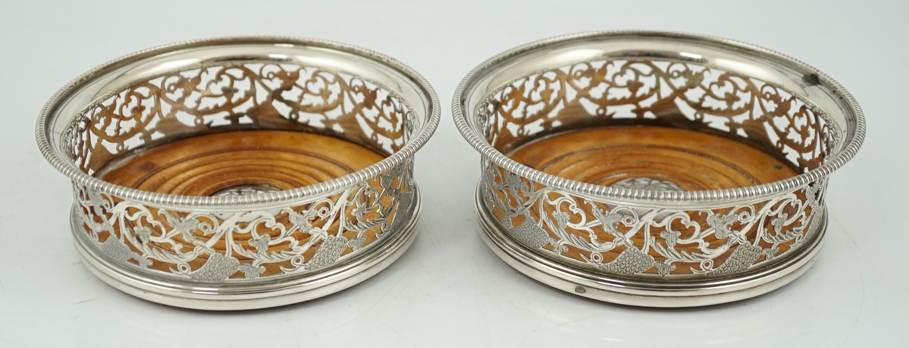 A pair of George III pierced silver mounted wine coasters, William Allen III